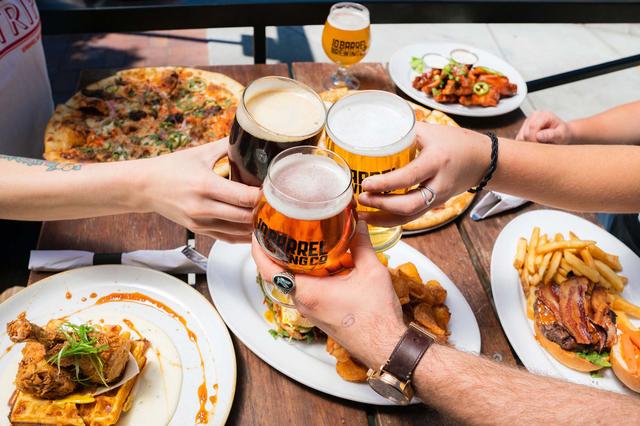 Picture of friends socializing over beer and pizza